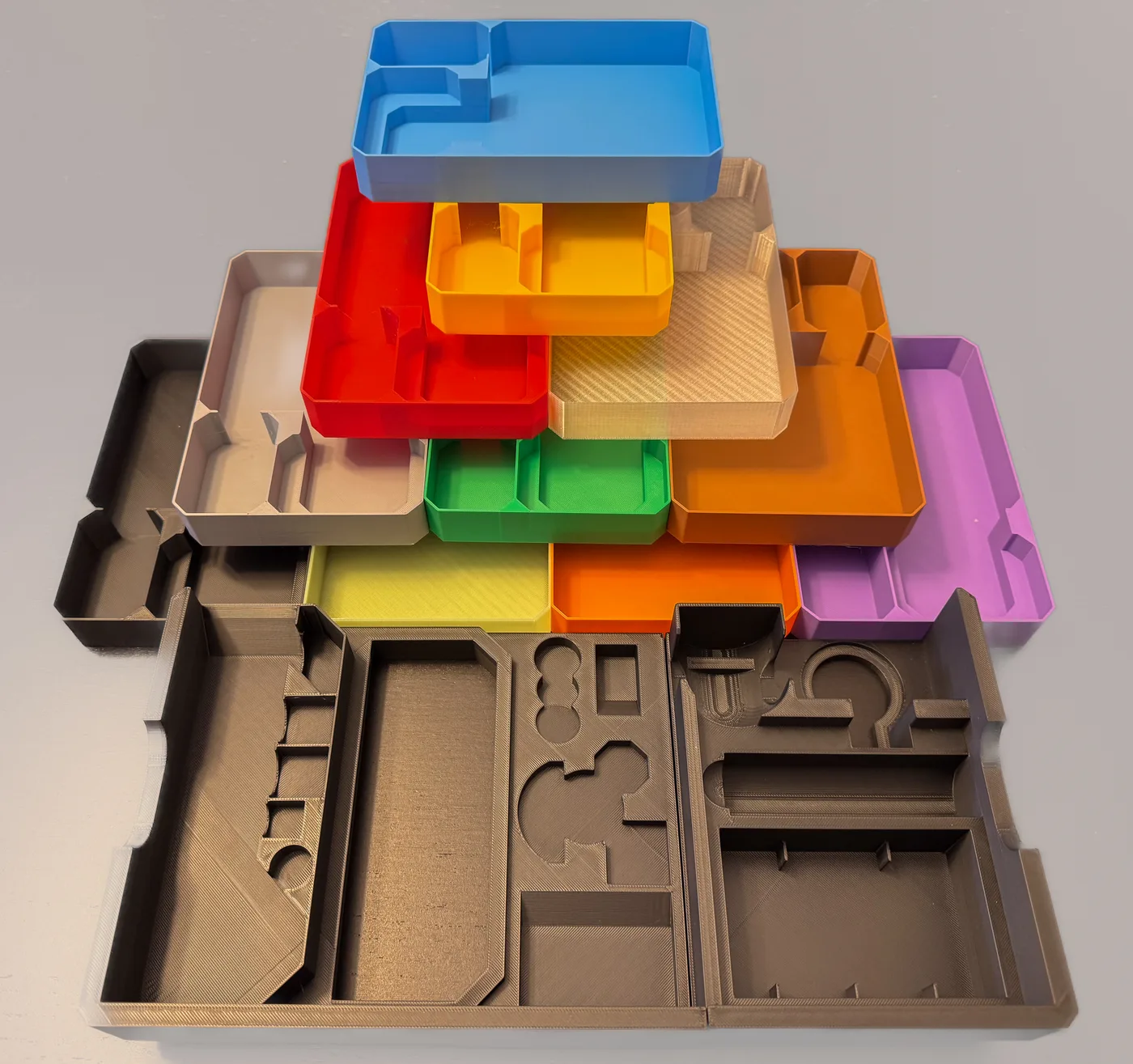 A stack of custom 3D-printed board-game insert trays
